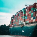 Close-up of a vessel with containers loaded on its deck as a symbol of importing and exporting goods to Europe.