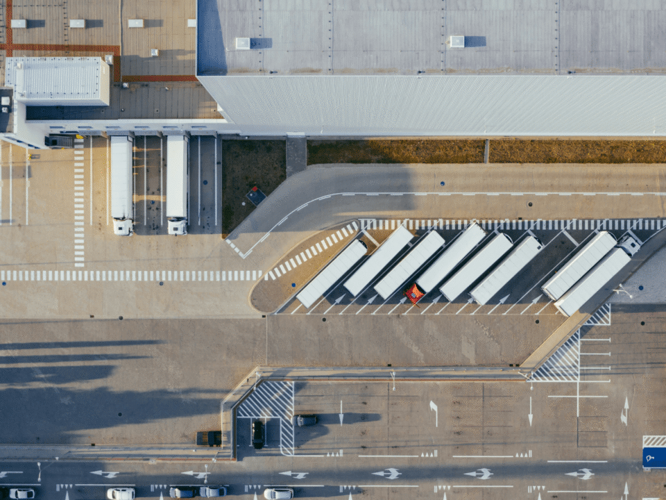Aerial view of a modern European logistics hub with loading docks and trucks, symbolizing nearshoring fulfilment operations in Europe.